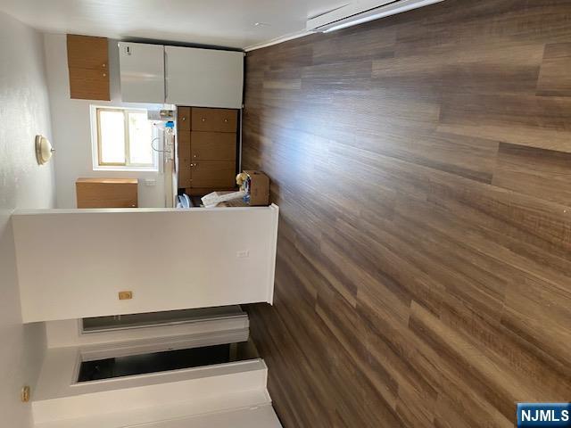 235 Mary Street, Unit 1 Hackensack, NJ 07601 - Photo 4 of 4 a kitchen with a refrigerator wooden floor and a sink