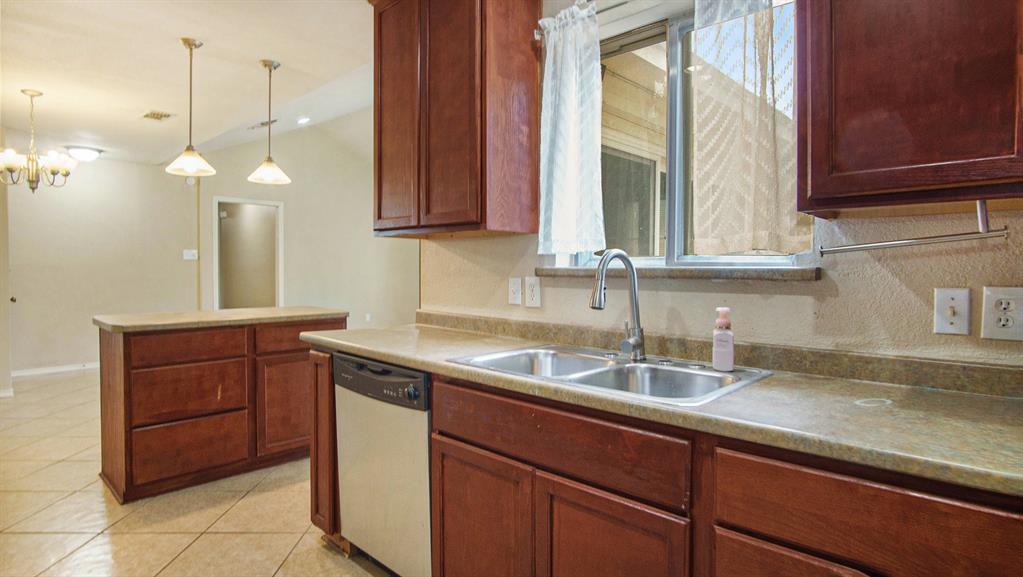 7600 Silveridge Drive Fort Worth, TX 76133 - Photo 12 of 24 a kitchen with a sink and a window