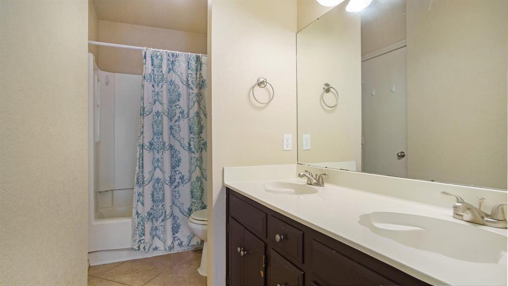 7600 Silveridge Drive Fort Worth, TX 76133 - Photo 17 of 24 a bathroom with a sink and a mirror