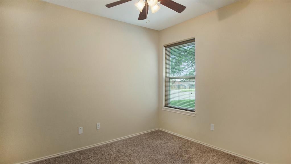7600 Silveridge Drive Fort Worth, TX 76133 - Photo 19 of 24 an empty room with a window and a fan