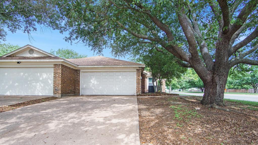 7600 Silveridge Drive Fort Worth, TX 76133 - Photo 2 of 24 a front view of a house with a yard and garage