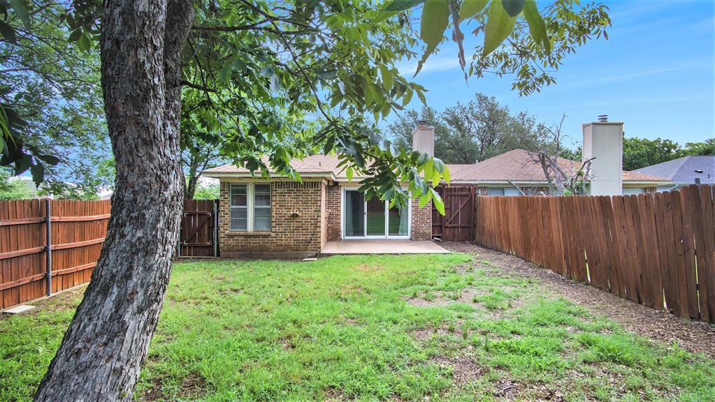 7600 Silveridge Drive Fort Worth, TX 76133 - Photo 22 of 24 front view of a house with a yard and an trees