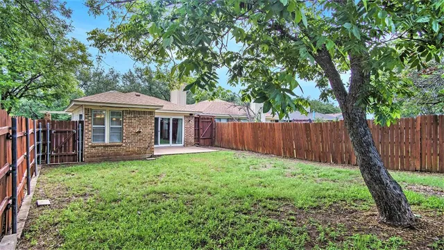 a view of a house with a yard and sitting area