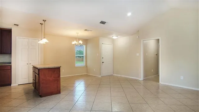 a view of a hallway with closet and a ceiling fan