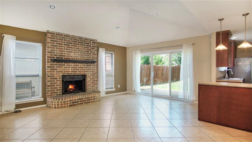 7600 Silveridge Drive Fort Worth, TX 76133 - Photo 5 of 24 a view of a livingroom with a fireplace and window