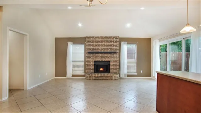 a view of a livingroom with a fireplace and window