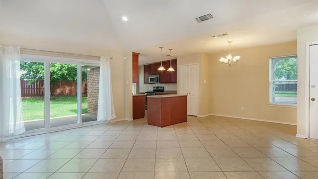 a view of a kitchen with furniture and an empty room