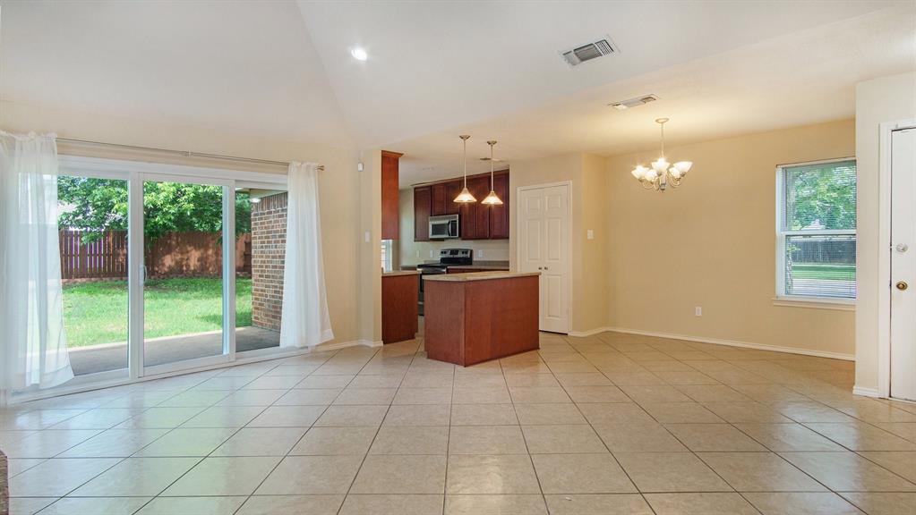 7600 Silveridge Drive Fort Worth, TX 76133 - Photo 8 of 24 a view of a kitchen with furniture and an empty room