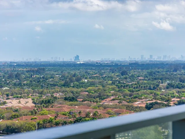 a view of a bathroom with two sinks and a window