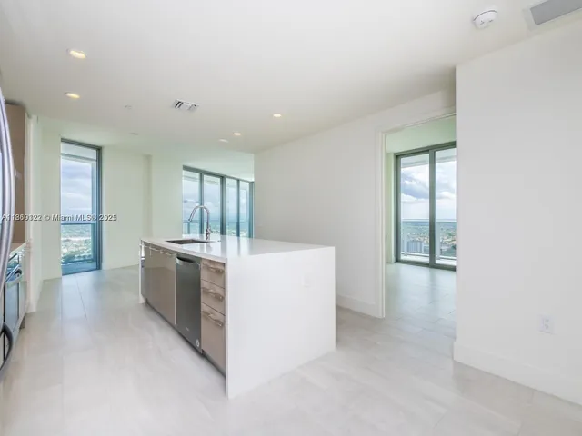 a kitchen with a refrigerator a stove and a sink