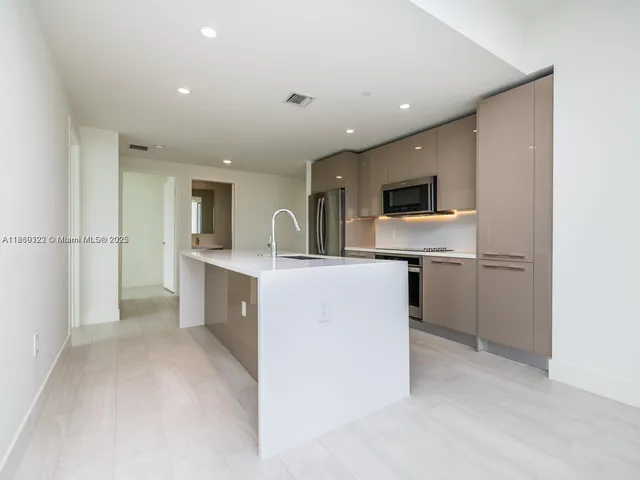 an empty room with windows and city view