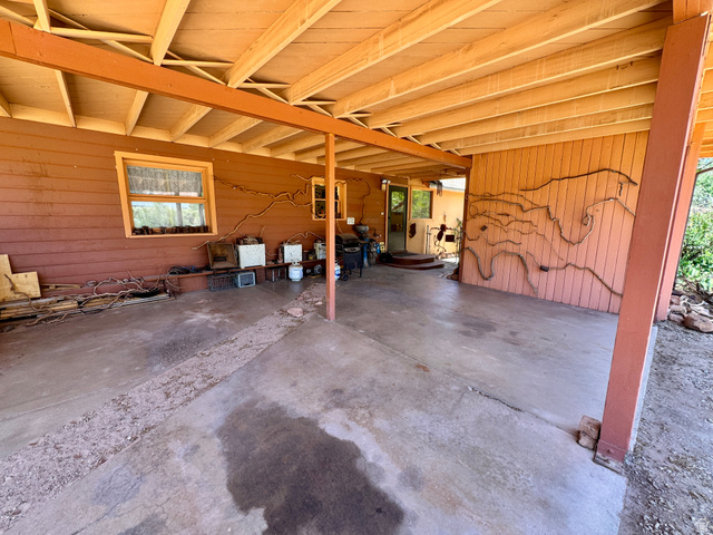 178 Walnut Lane Moab, UT 84532 - Photo 9 of 25 Covered outdoor patio with exposed beam ceiling and concrete flooring