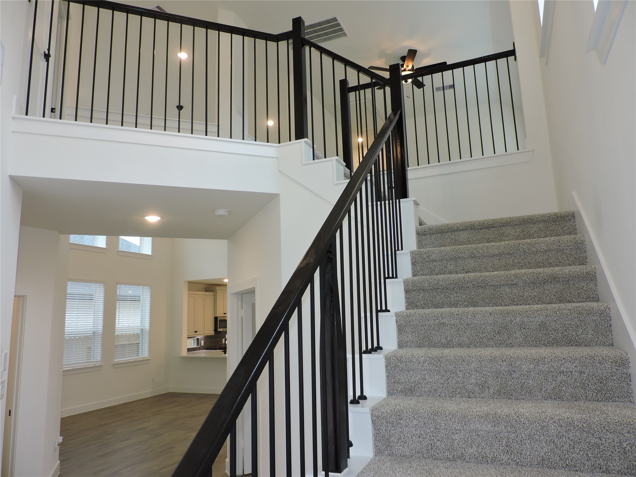 12853 Meadow Wind Way Conroe, TX 77302 - Photo 29 of 47 Going up the stairs with beautifully designed wrought iron spindles and stained wood rails