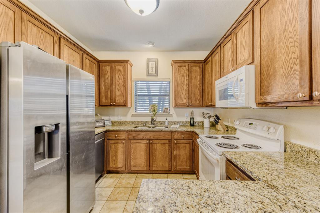 6525 Greenway Road Fort Worth, TX 76116 - Photo 6 of 29 a large kitchen with a stove a sink dishwasher a refrigerator and cabinets