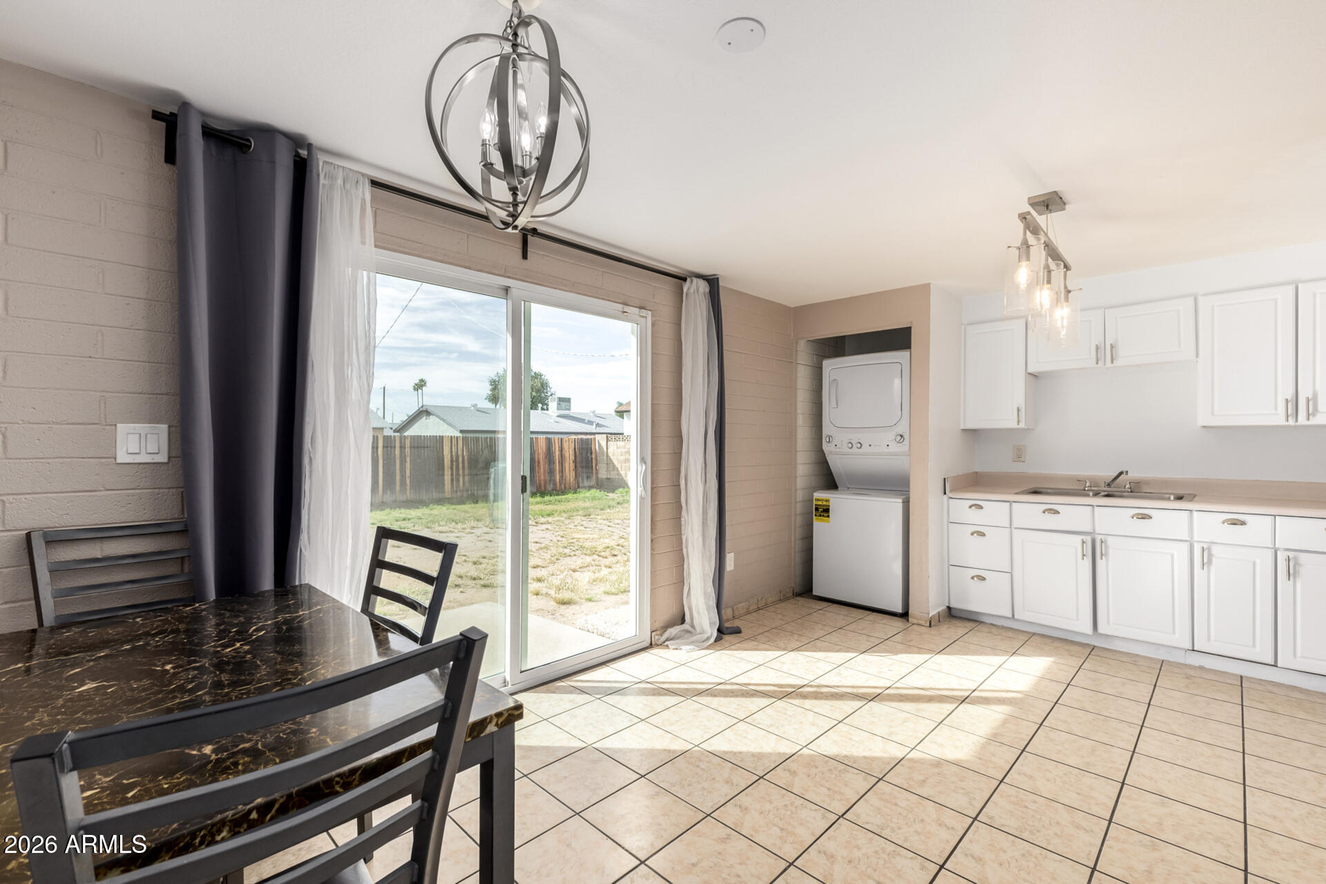 7265 West Camelback Road Phoenix, AZ 85033 - Photo 11 of 31 a kitchen with stainless steel appliances a stove a sink and a chandelier