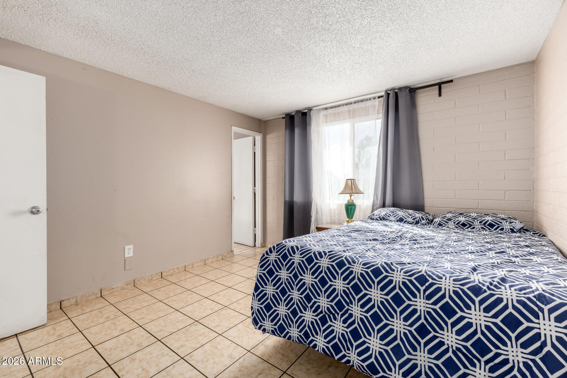 7265 West Camelback Road Phoenix, AZ 85033 - Photo 18 of 31 a bedroom with a bed and a window