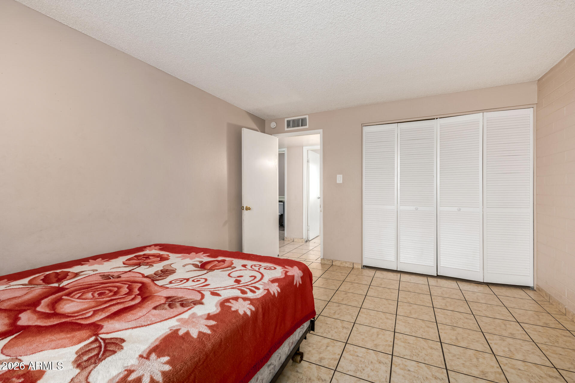 7265 West Camelback Road Phoenix, AZ 85033 - Photo 24 of 31 a spacious bedroom with a bed and a shower
