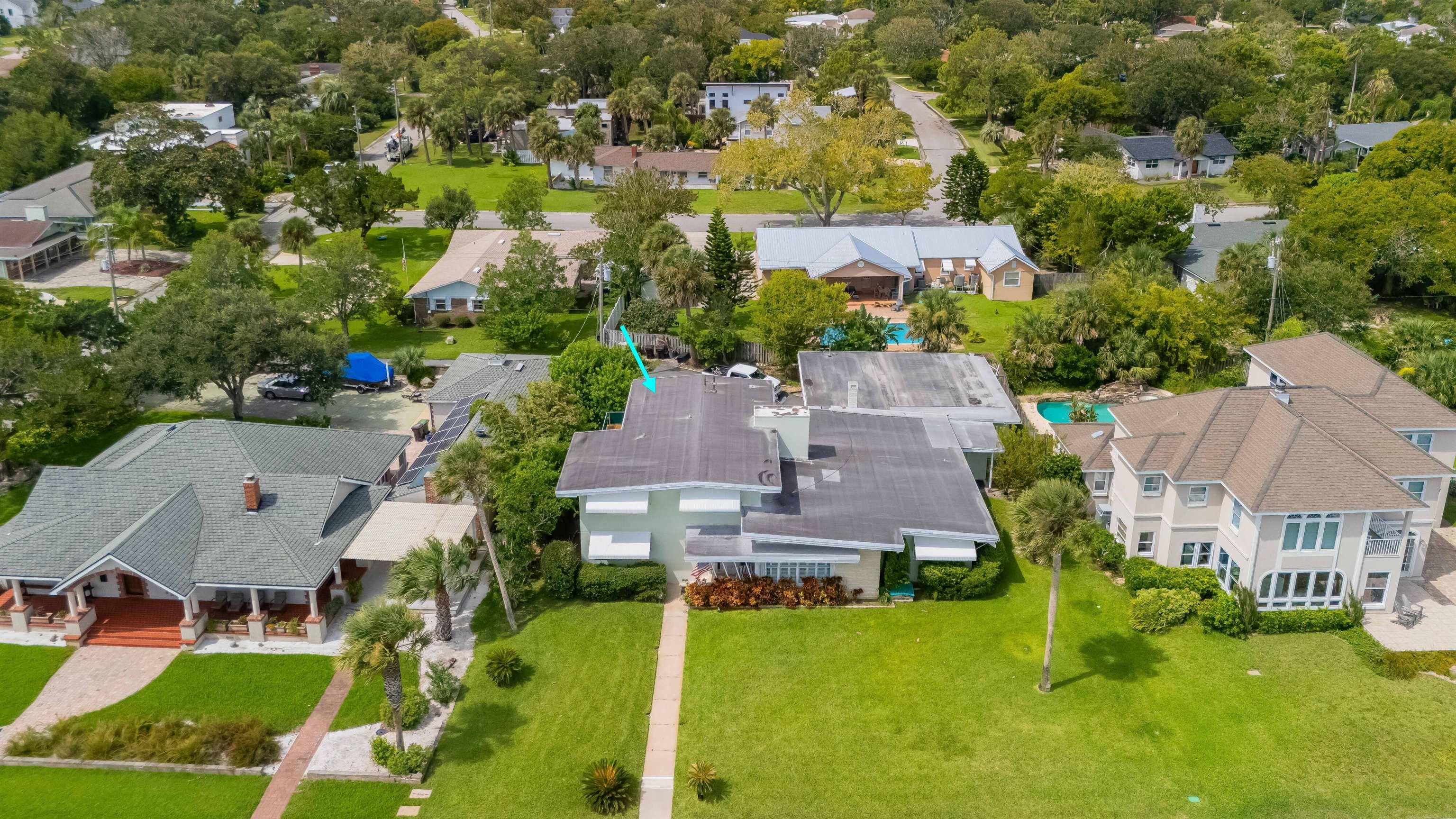 an aerial view of residential houses with yard