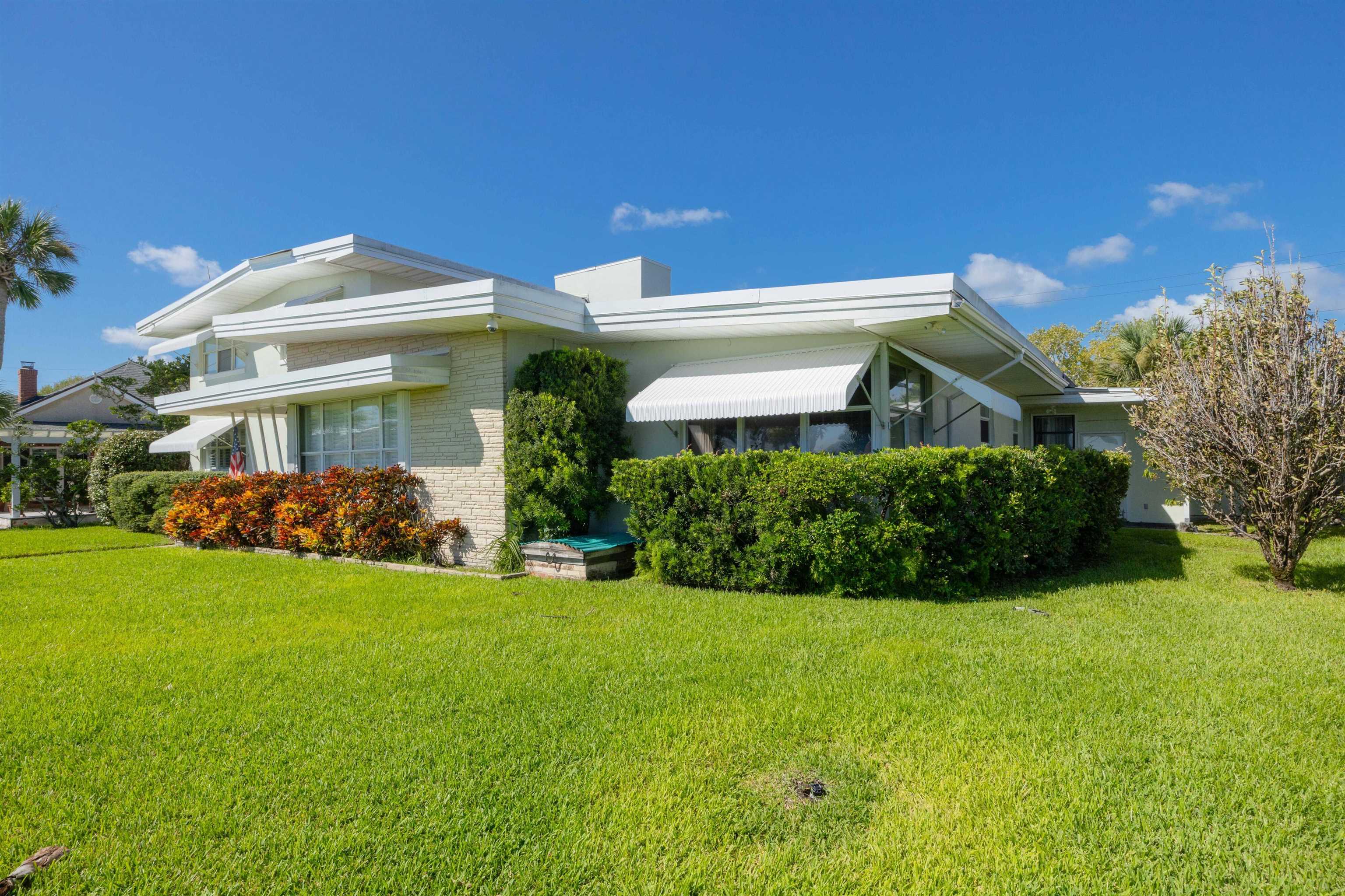 124 Inlet Drive St. Augustine, FL 32080 - Photo 13 of 45 a front view of a house with a garden
