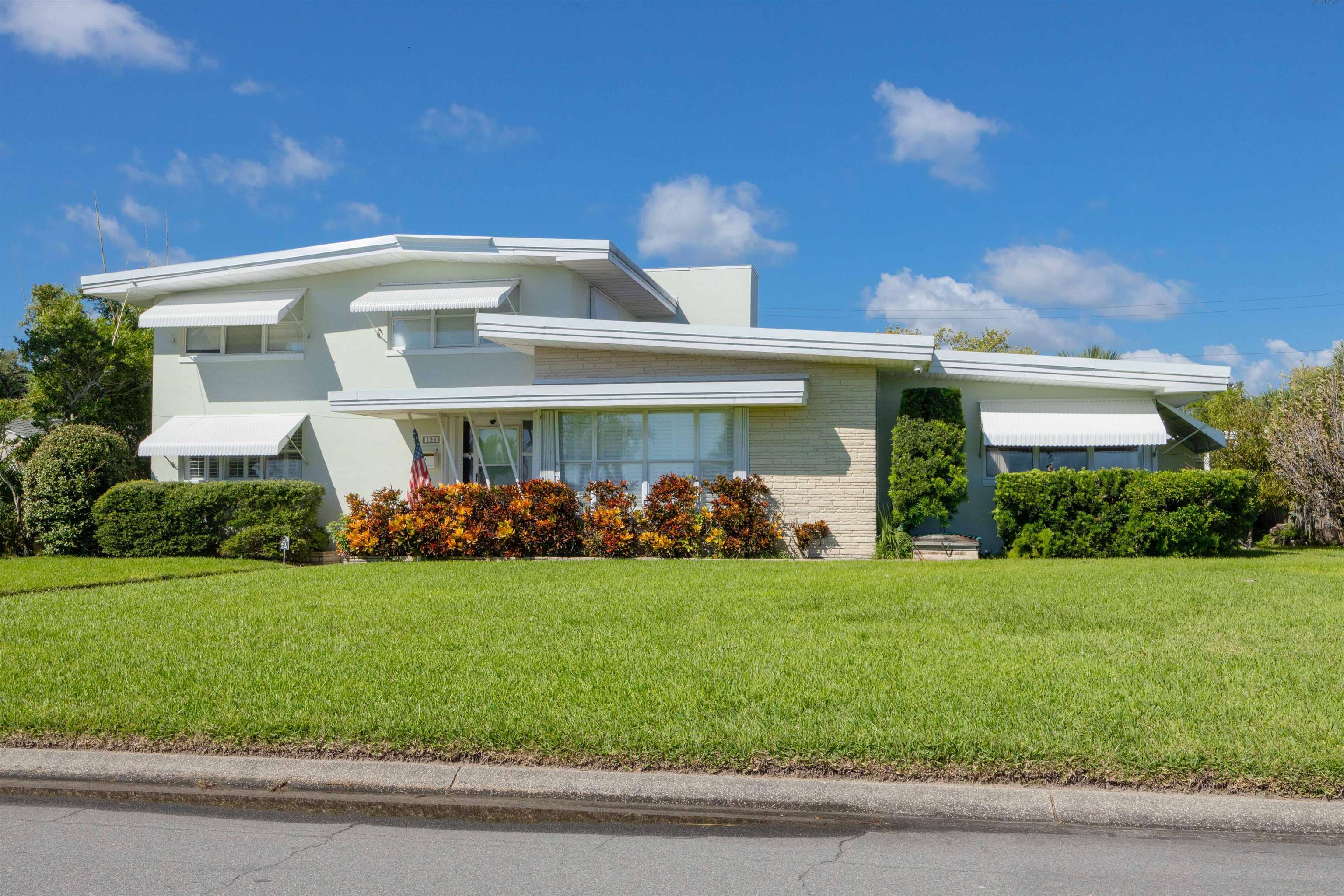 124 Inlet Drive St. Augustine, FL 32080 - Photo 5 of 45 a front view of a house with a garden