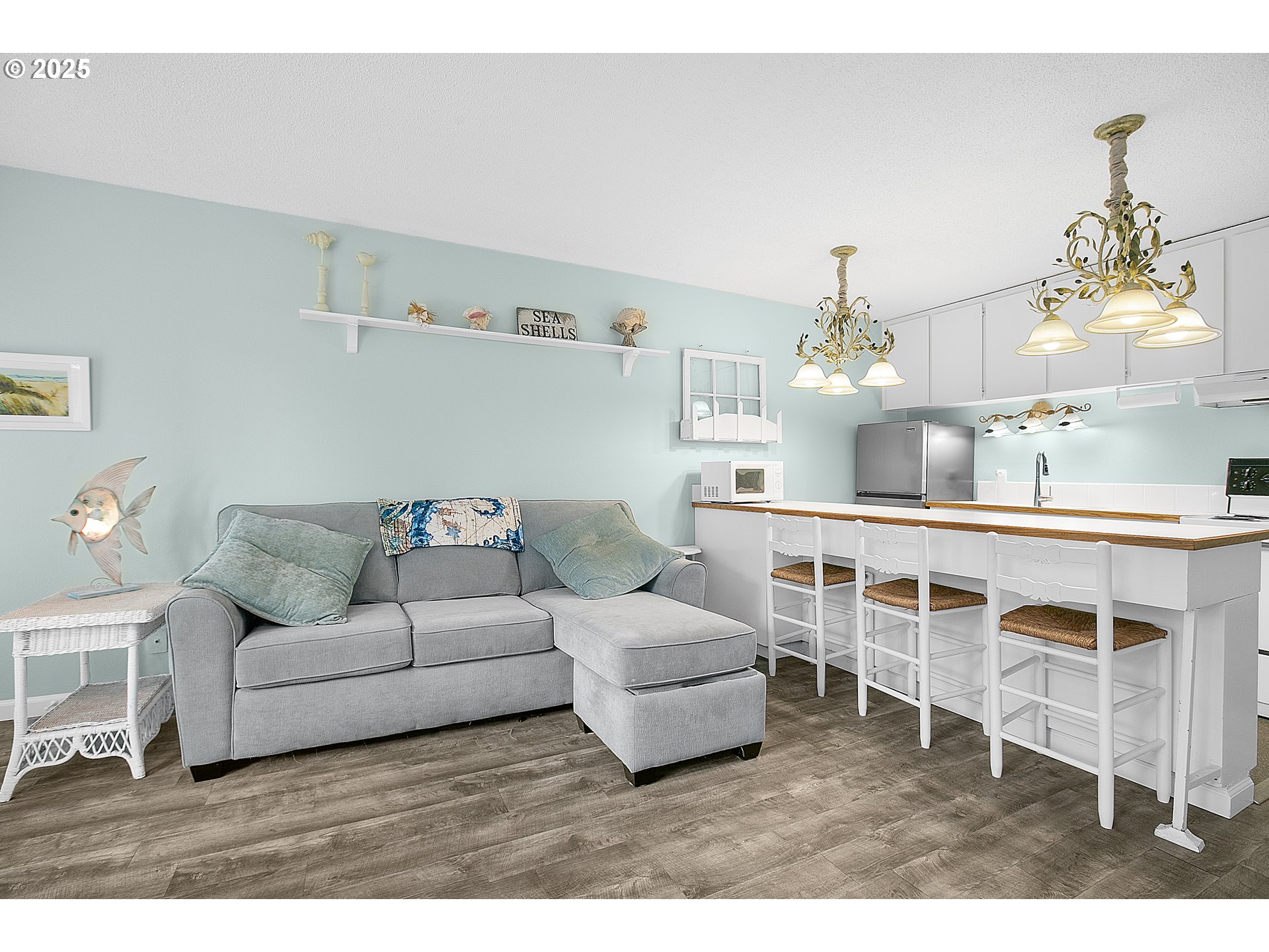 48988 Highway 101, Unit 137F Neskowin, OR 97149 - Photo 11 of 29 a living room with furniture a chandelier and kitchen view