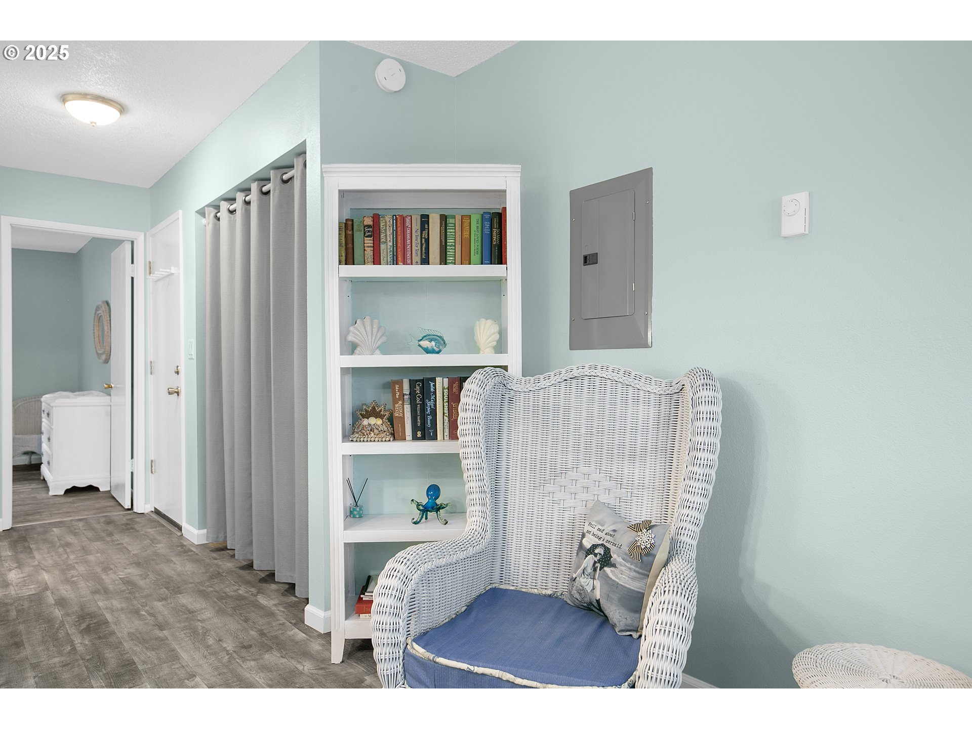 48988 Highway 101, Unit 137F Neskowin, OR 97149 - Photo 15 of 29 a living room with furniture and a book shelf