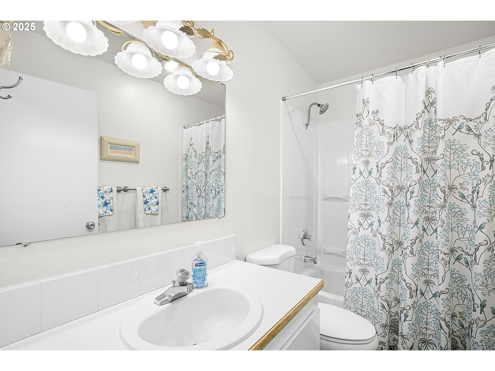 48988 Highway 101, Unit 137F Neskowin, OR 97149 - Photo 19 of 29 a bathroom with a sink a toilet a mirror and shower