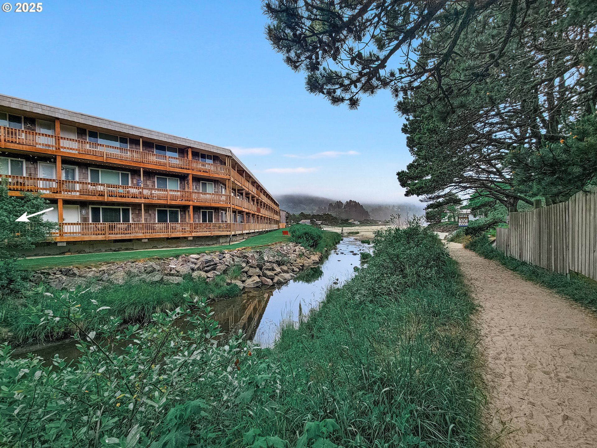 48988 Highway 101, Unit 137F Neskowin, OR 97149 - Photo 21 of 29 a view of a house with a yard and sitting area