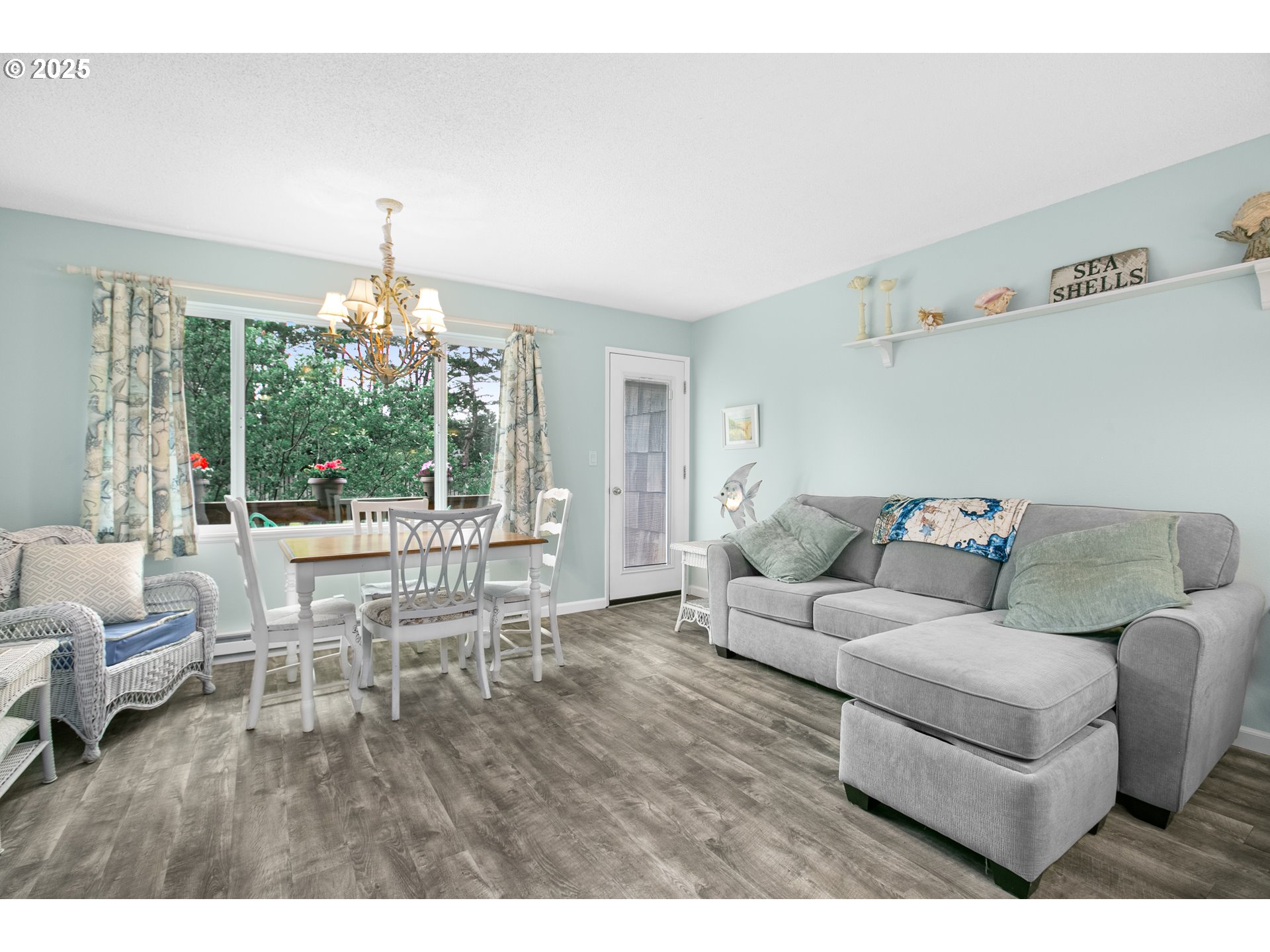 48988 Highway 101, Unit 137F Neskowin, OR 97149 - Photo 7 of 29 a living room with furniture and a chandelier