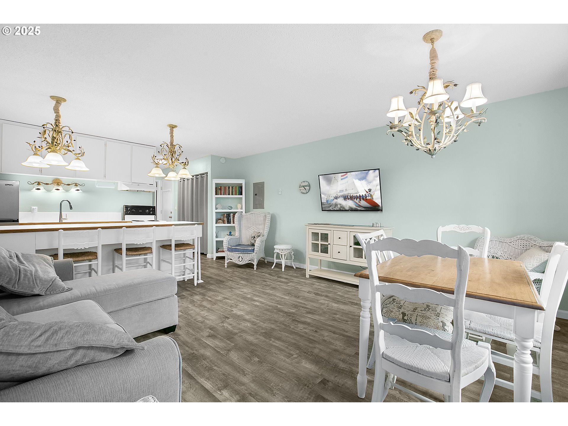 48988 Highway 101, Unit 137F Neskowin, OR 97149 - Photo 10 of 29 a living room with furniture and a chandelier