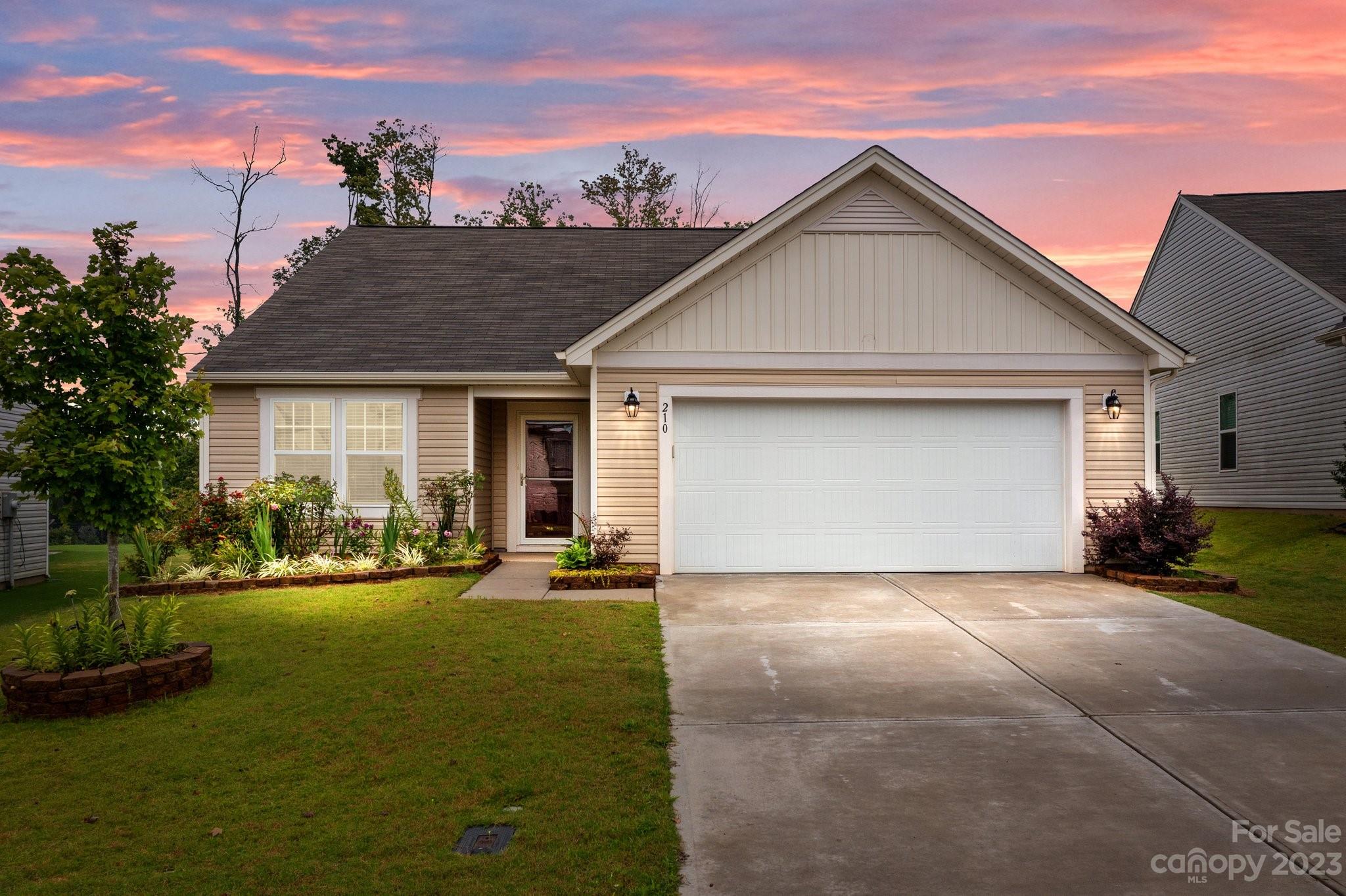 a front view of house with yard and green space