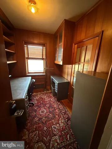 a view of an empty room with a fireplace and a window
