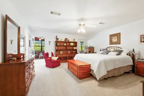 a spacious bedroom with a bed and a chandelier