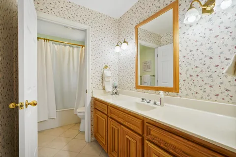 a bathroom with a sink a mirror and a shower