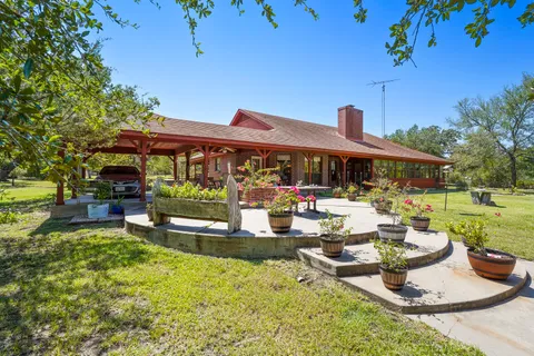 a front view of a house with swimming pool having outdoor seating