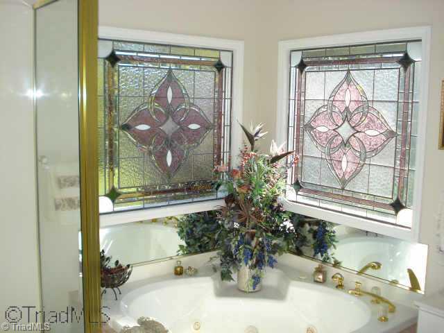 204 Helsabeck Road King, NC 27021 - Photo 9 of 9 Other. Master Bath features a corner jetted tub and double stained glass windows to allow light in but no one can see inside.