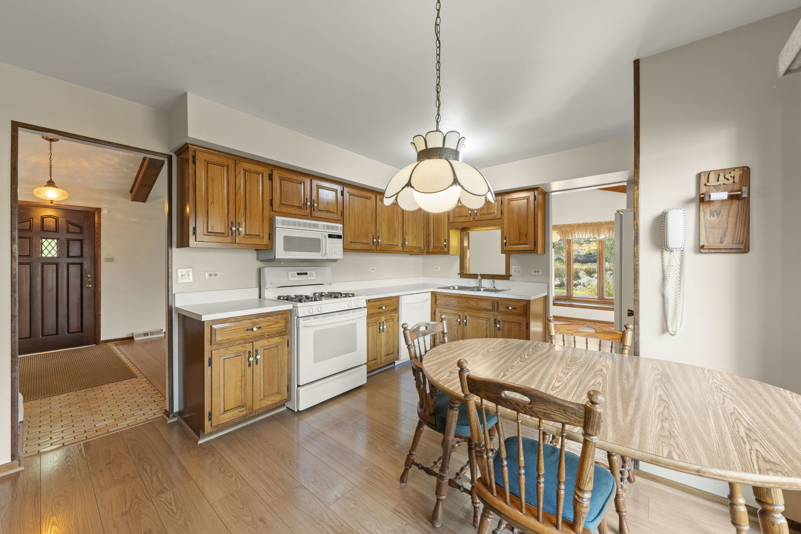 3068 Hickory Road Homewood, IL 60430 - Photo 9 of 44 a kitchen with cabinets a sink stainless steel appliances and dining table