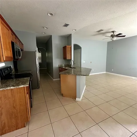 a kitchen with stainless steel appliances granite countertop a sink and a stove