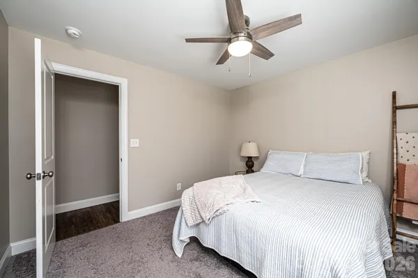 a bedroom with a bed and a ceiling fan