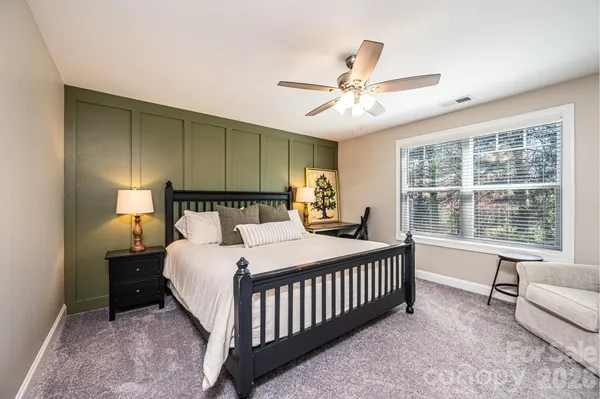 a bedroom with a bed and a large window