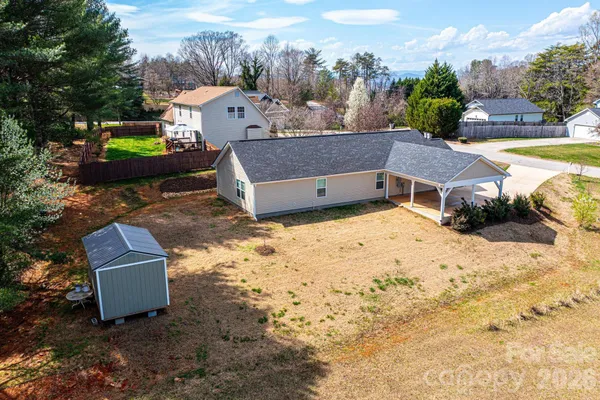 a view of a houses with yard and snow