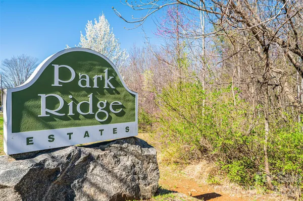 a wooden door with a sign and a car park