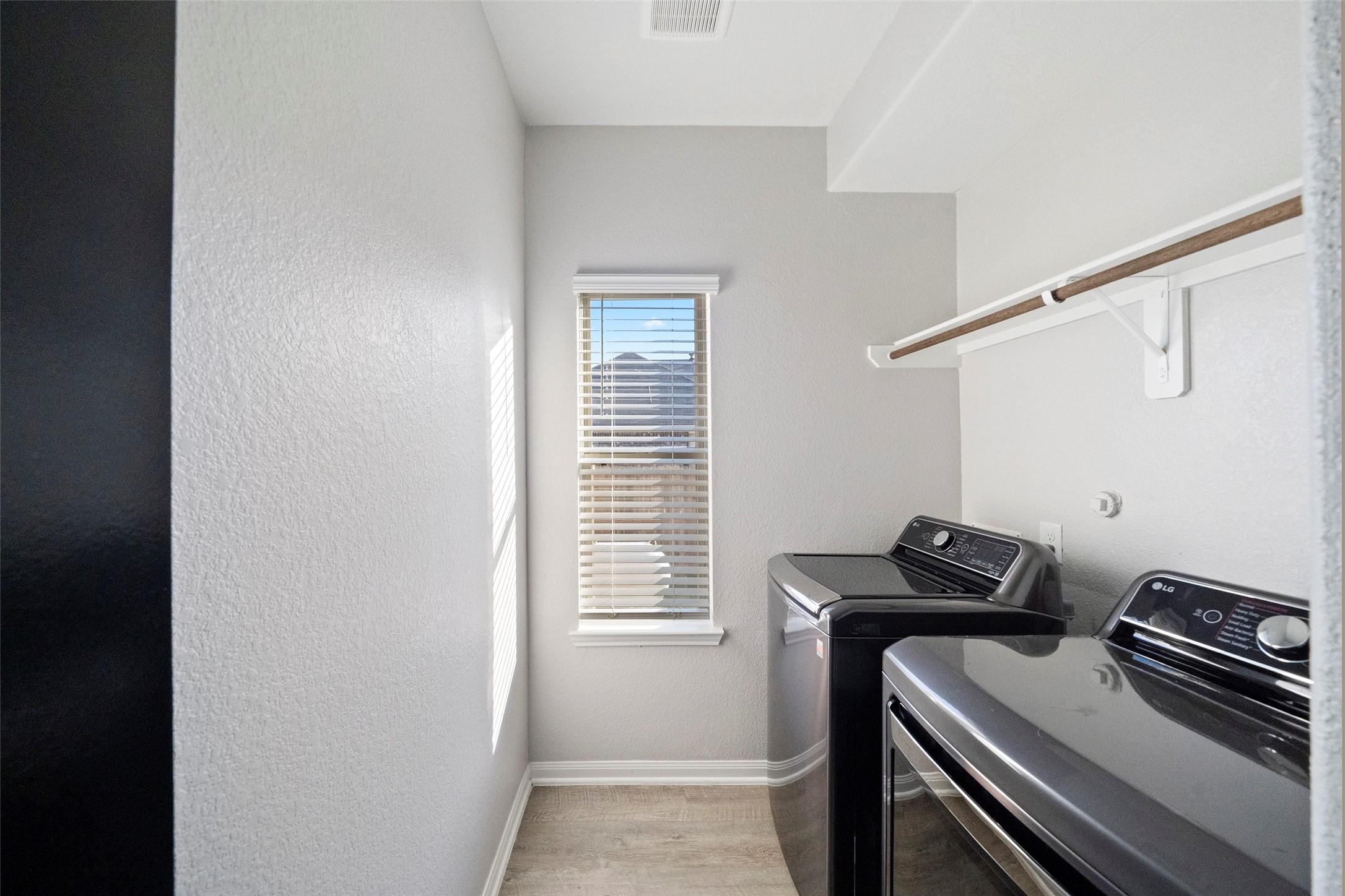 6161 White Oak Leaf Loop Conroe, TX 77303 - Photo 3 of 25 a view of storage and utility room with washer and dryer