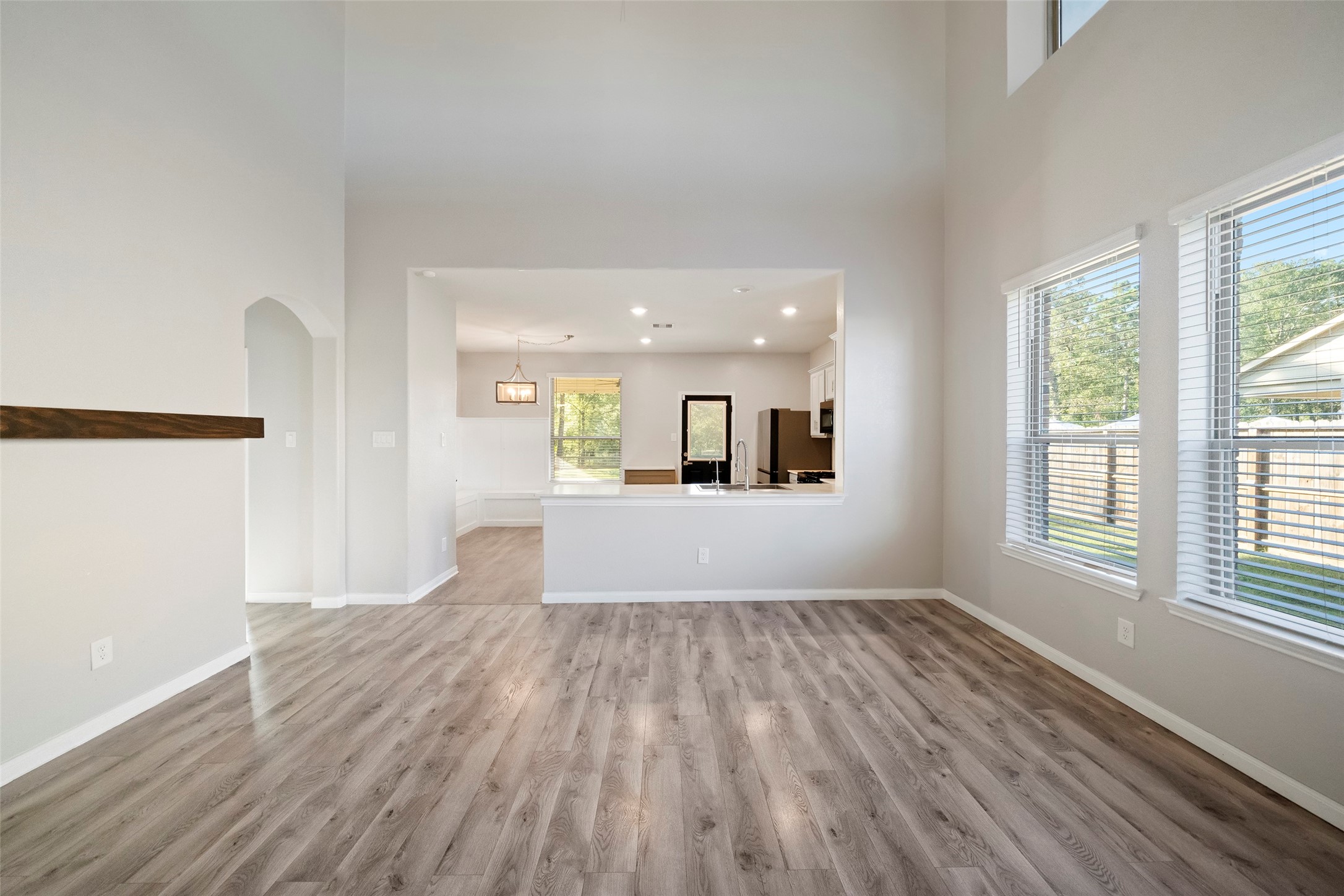 6161 White Oak Leaf Loop Conroe, TX 77303 - Photo 8 of 25 wooden floor in an empty room with a window