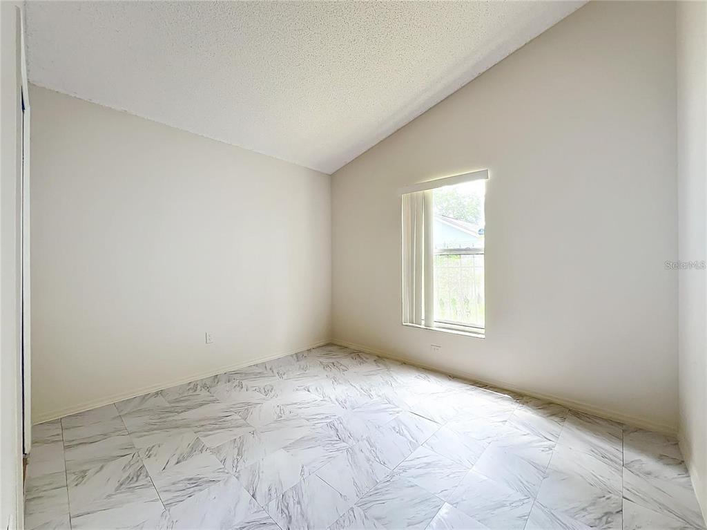 5633 Piney Ridge Drive Orlando, FL 32808 - Photo 16 of 18 an empty room with a window