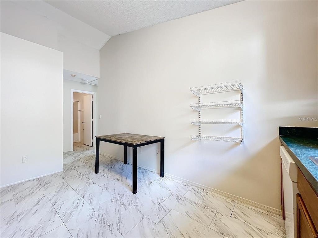 5633 Piney Ridge Drive Orlando, FL 32808 - Photo 17 of 18 a view of a room that has a bed and a window in it