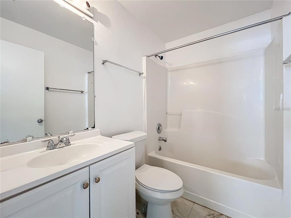 5633 Piney Ridge Drive Orlando, FL 32808 - Photo 18 of 18 a bathroom with a sink toilet and shower