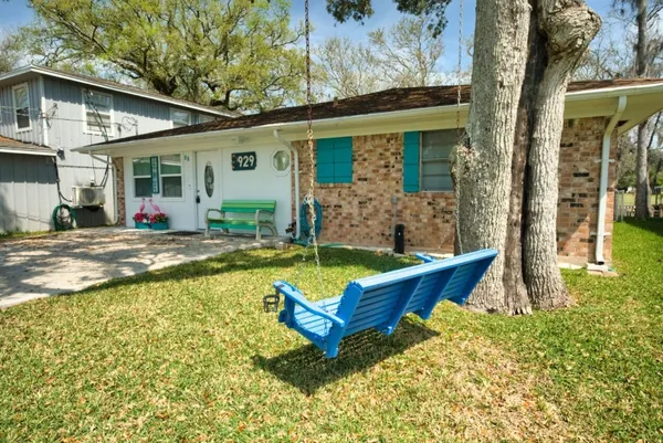 a view of a house with pool and sitting area