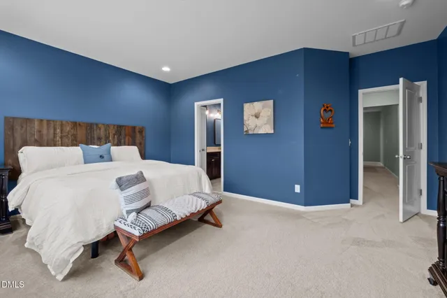 a bed room with a bed and a chair