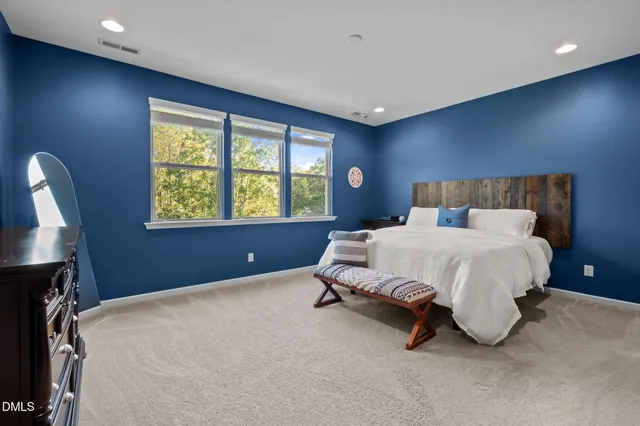 a bed sitting in a room next to a window